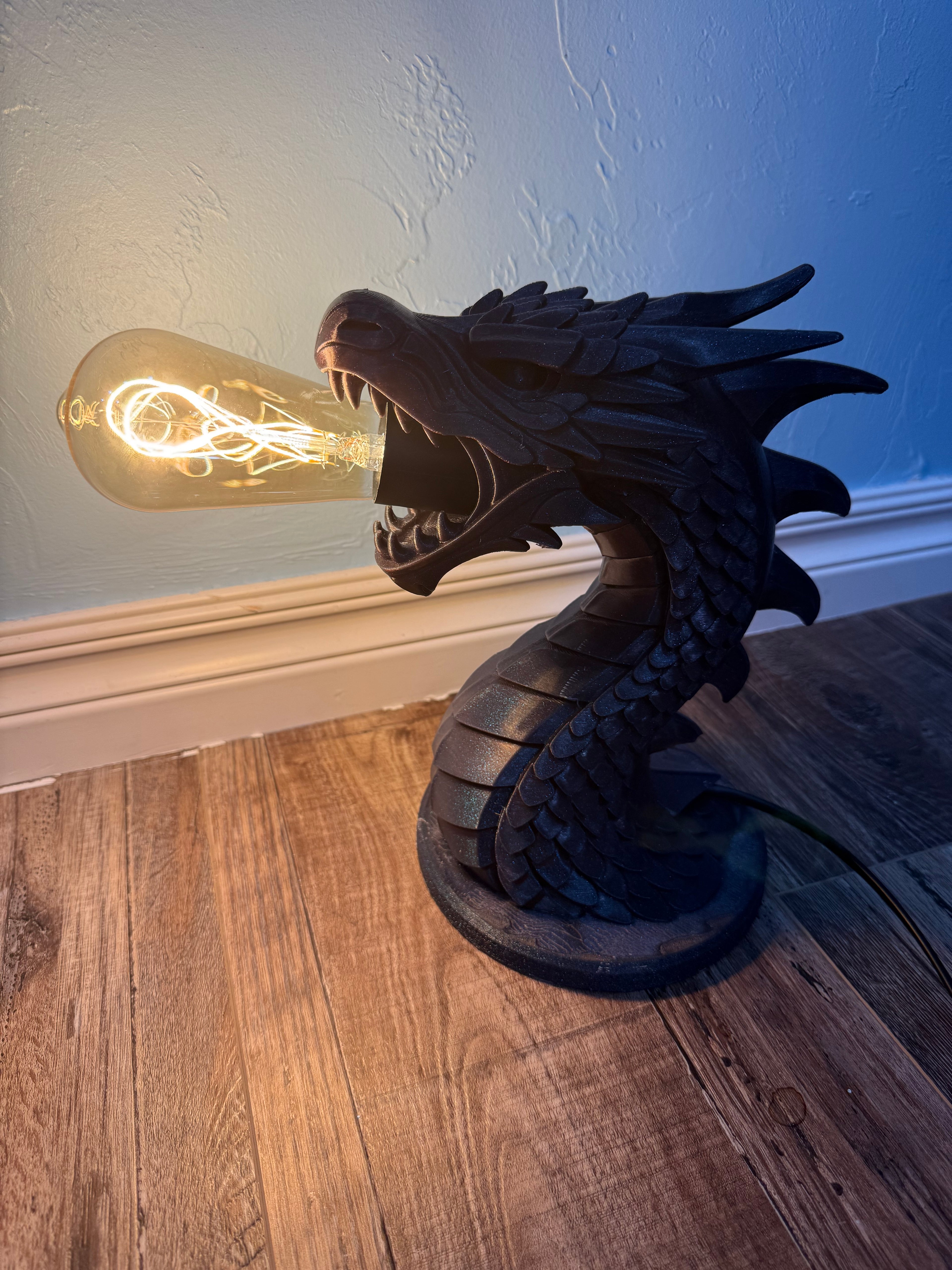 3D printed dragon lamp with Edison bulb glowing in its open mouth
